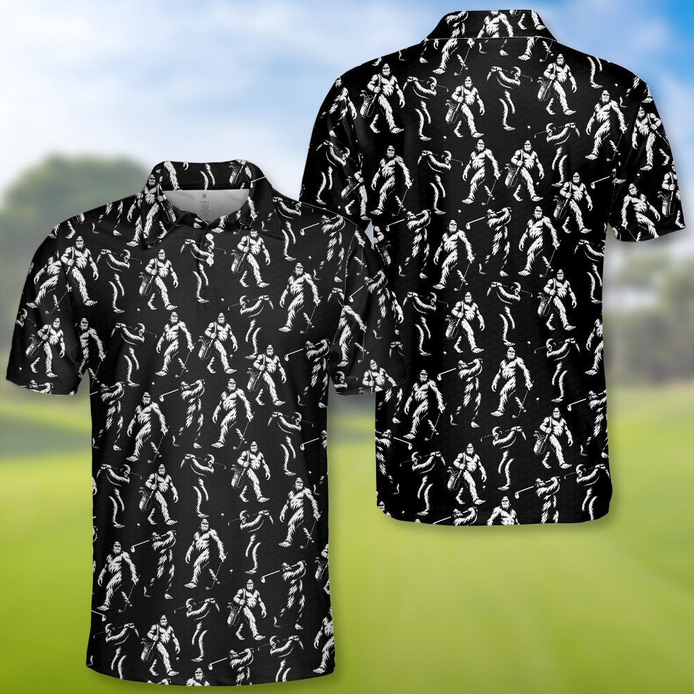 Black bigfoot polo shirt featuring white bigfoot figures golfing, flat lay front view