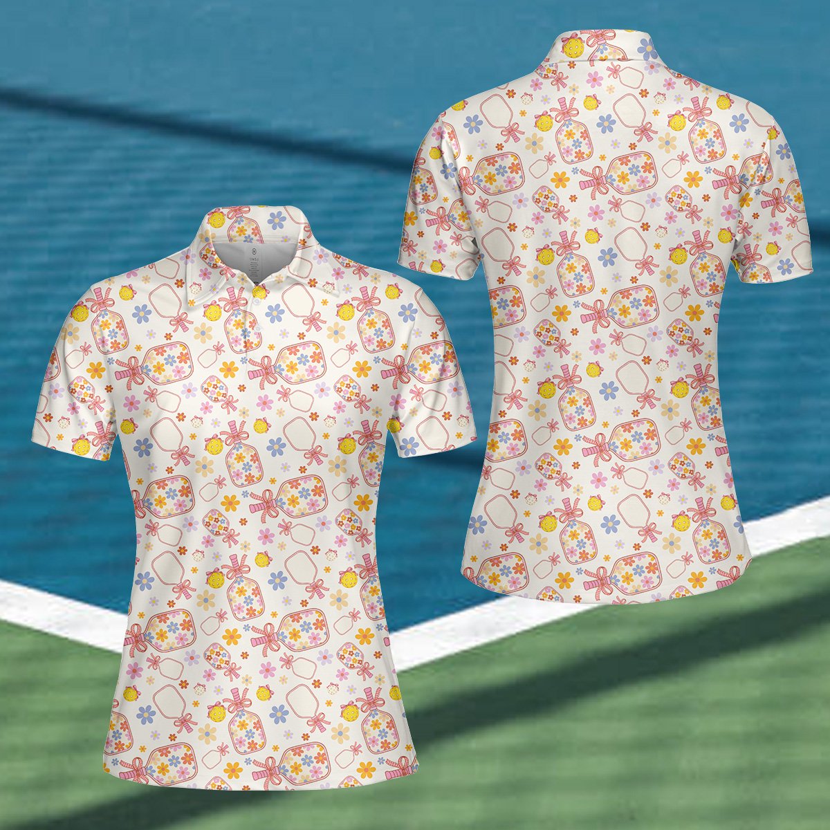 White floral polo shirt with pickleball paddles and flowers, flat lay front view