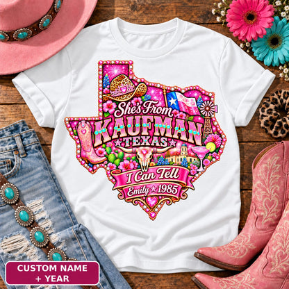 Personalized She's From Kaufman Texas I Can Tell t-shirt on White, custom name and year badge, pink glitter Texas with rhinestone border, leopard cowgirl hat, flag, boots, longhorn and custom name and year banner NEW2