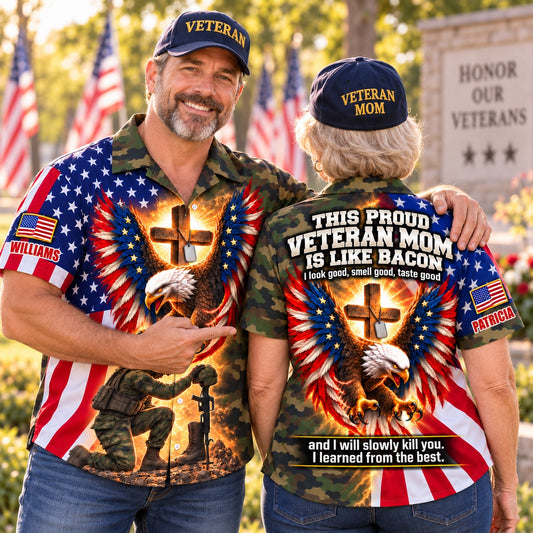Veteran dad and veteran mom couple in matching personalized camo eagle and cross Hawaiian shirts with custom names at a veterans memorial, front and back views
