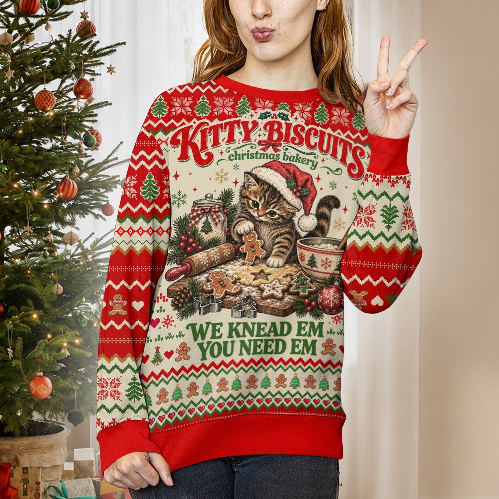 Person wearing the green Christmas cat bakery ugly sweater