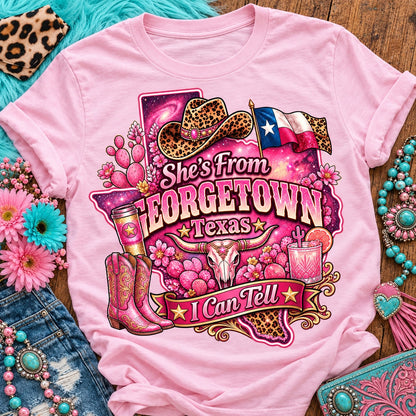 She's From Georgetown Texas I Can Tell pink cowgirl t-shirt, galaxy Texas, leopard hat, boots and longhorn design on a Blossom Comfort Colors 1717 tee