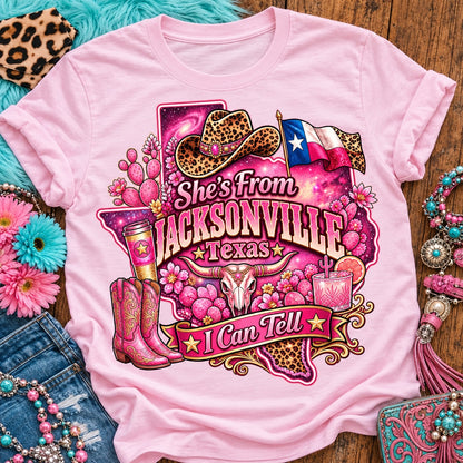 She's From Jacksonville Texas I Can Tell pink cowgirl t-shirt, galaxy Texas, leopard hat, boots and longhorn design on a Blossom Comfort Colors 1717 tee