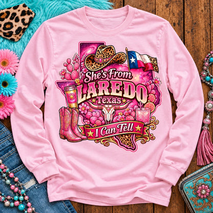She's From Laredo Texas I Can Tell pink cowgirl long sleeve, galaxy Texas, leopard hat, boots and longhorn design on Light Pink