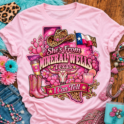 She's From Mineral Wells Texas I Can Tell pink cowgirl t-shirt, galaxy Texas, leopard hat, boots and longhorn design on a Blossom Comfort Colors 1717 tee