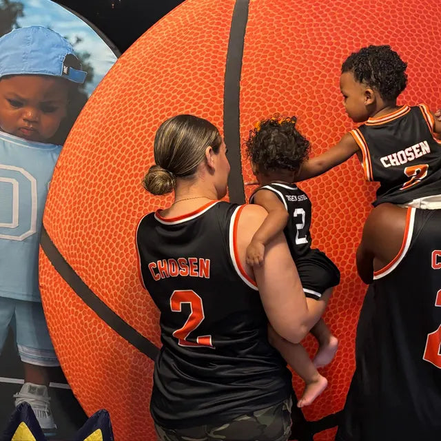 Family wearing matching basketball jerseys